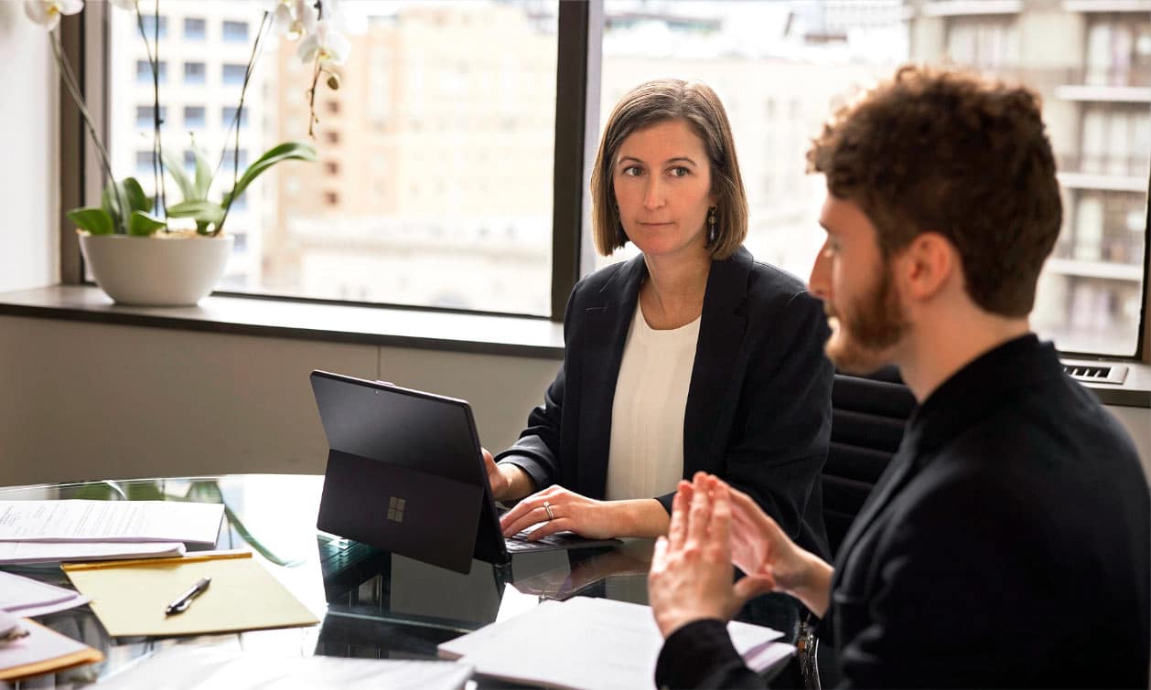 Whistleblowing solicitor advising colleagues in a professional office environment