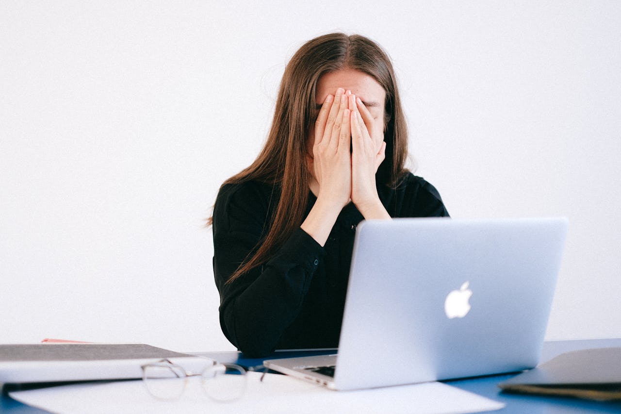 An office setting with an employee appearing uncomfortable as a colleague stands too close, symbolising workplace harassment.