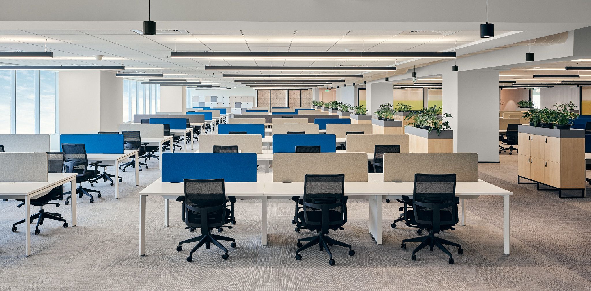 An office setting with an employee appearing uncomfortable as a colleague stands too close, symbolising workplace harassment.